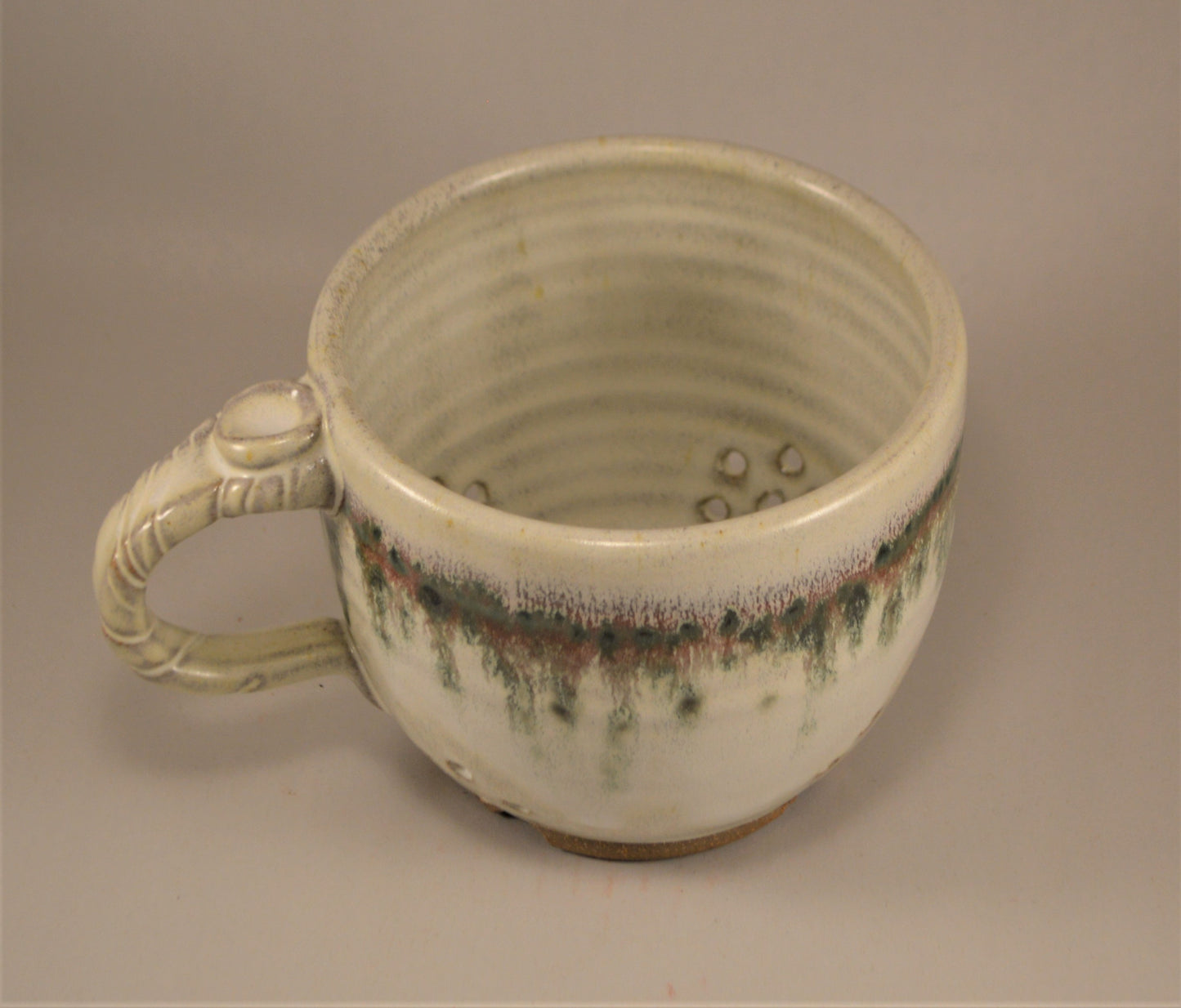 Pottery Berry colander with handle and Trout green glaze
